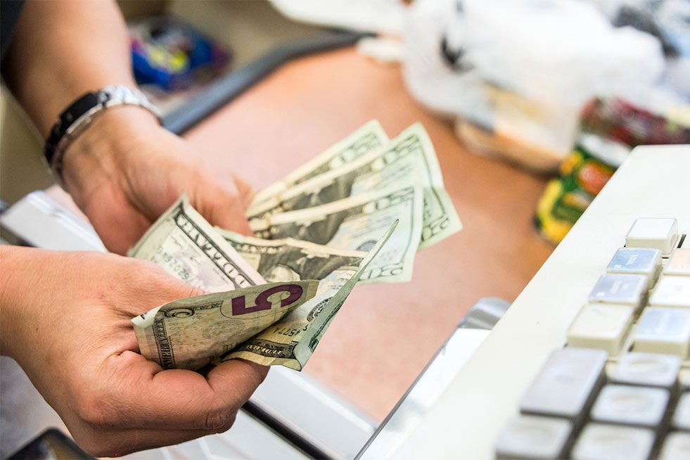 conv.-store man counting money